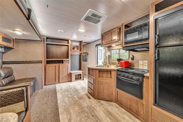 a living room with patio furniture and a flat screen tv
