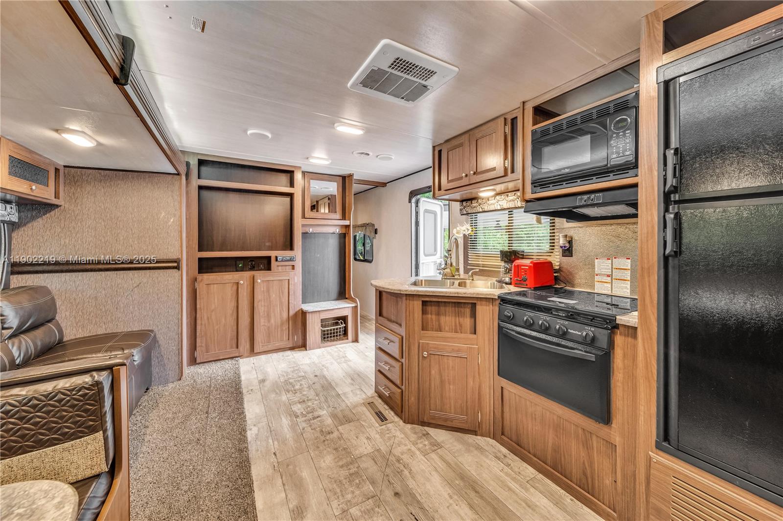 710 Northeast 141st Street North Miami, FL 33161 - Photo 27 of 78 a kitchen with granite countertop a refrigerator stove and microwave