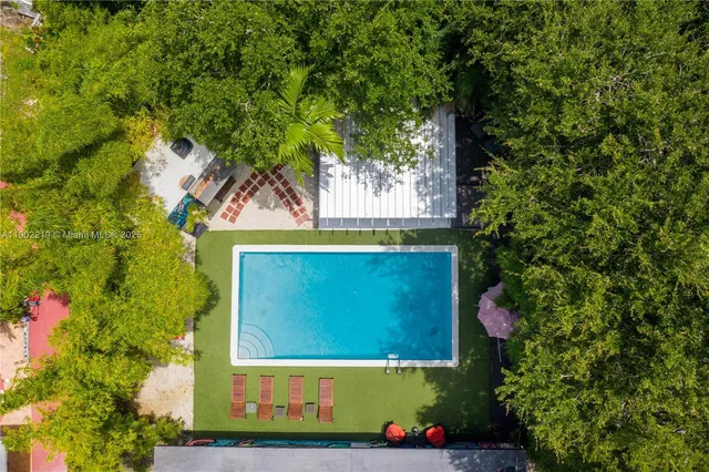 a front view of house with a garden