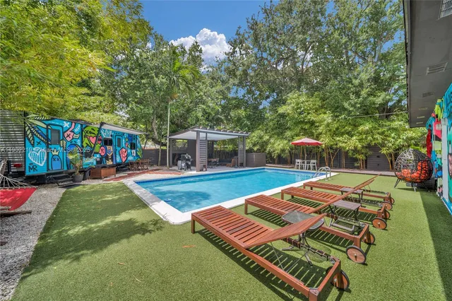 an outdoor space with swimming pool and furniture