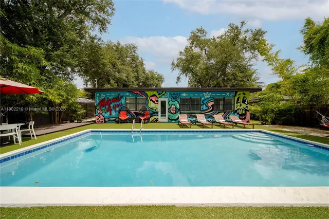 a view of a backyard with a patio and outdoor seating