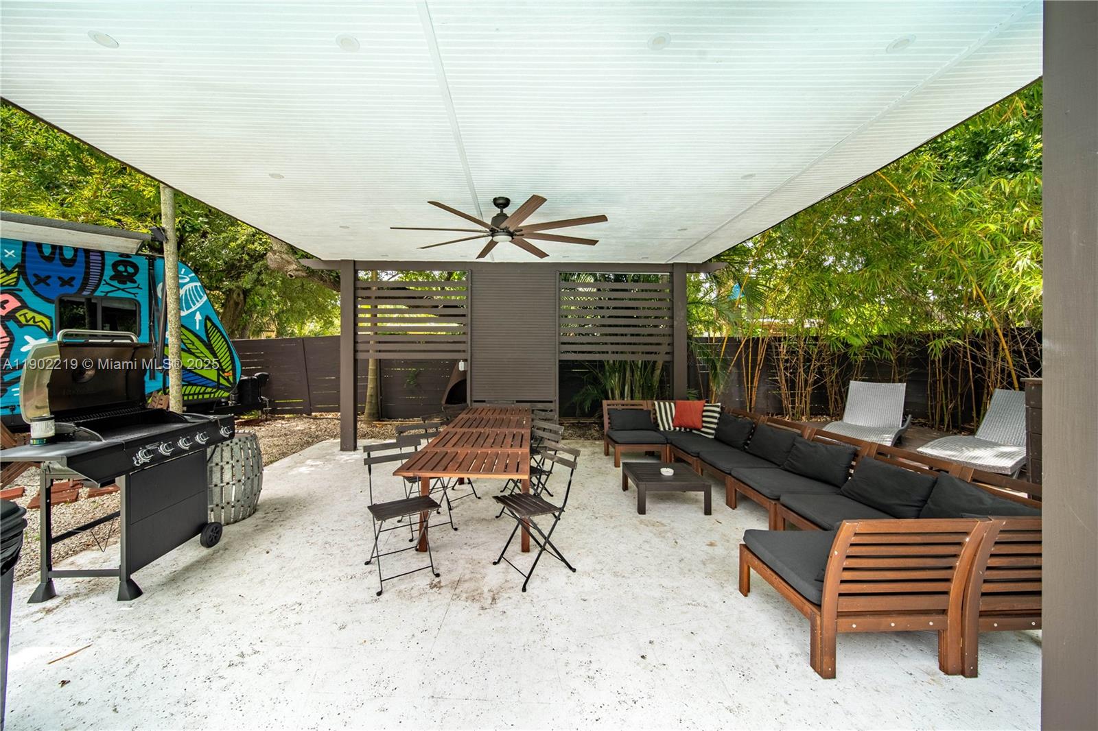 710 Northeast 141st Street North Miami, FL 33161 - Photo 37 of 78 a living room with patio furniture and a flat screen tv