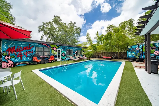 a view of swimming pool a patio and fire pit