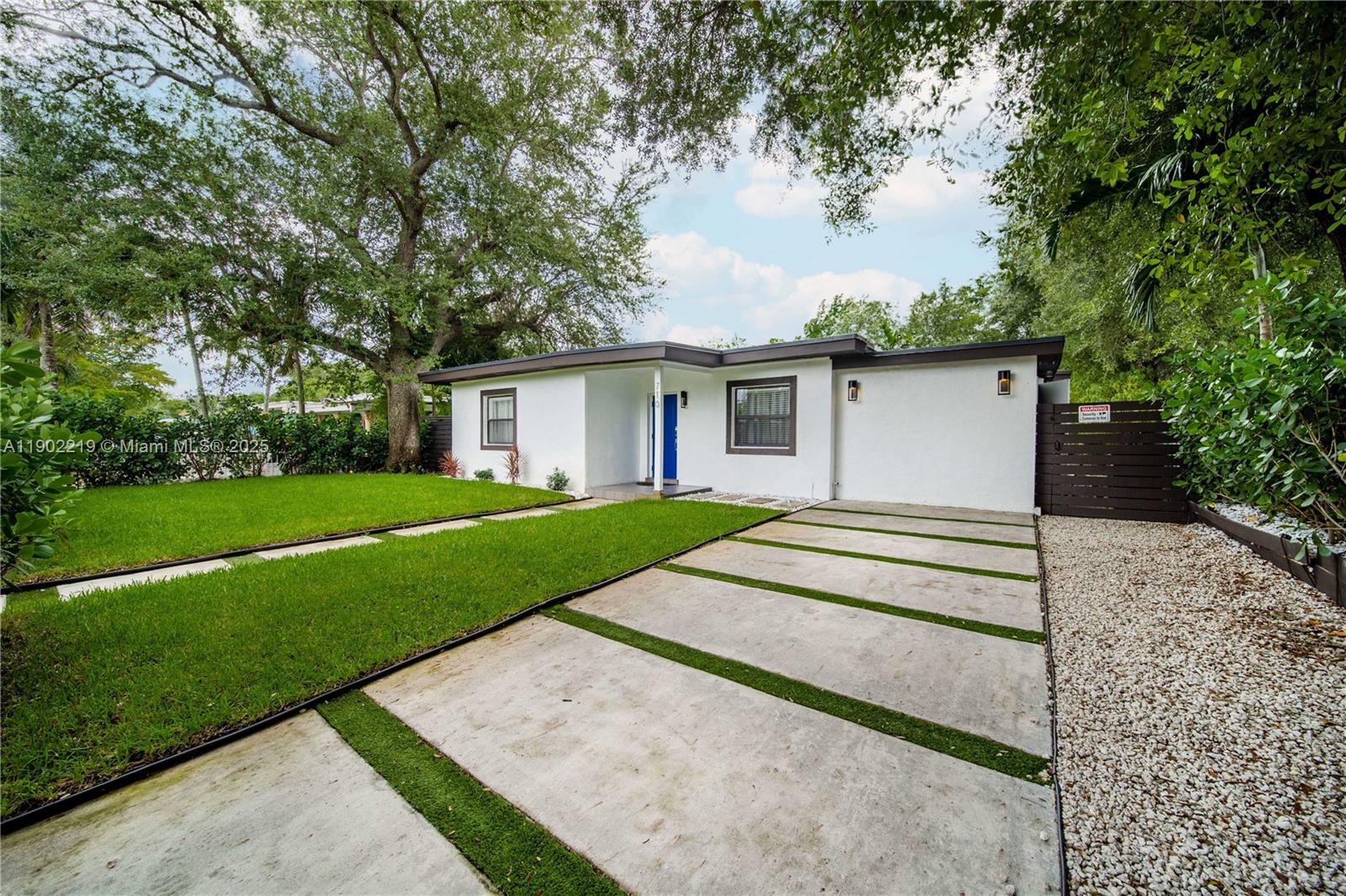 710 Northeast 141st Street North Miami, FL 33161 - Photo 40 of 78 a view of a house with a yard and large tree