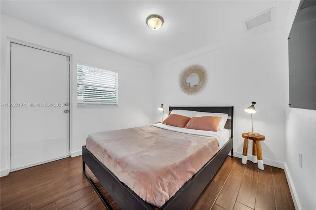 a kitchen with stainless steel appliances granite countertop a sink a stove and a wooden floors