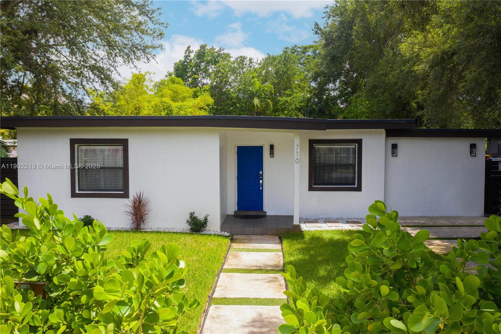 710 Northeast 141st Street North Miami, FL 33161 - Photo 43 of 78 a front view of a house with garden