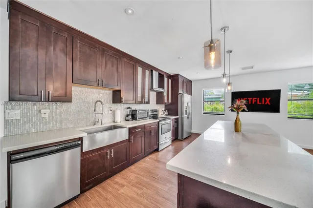 a living room with lots of furniture and kitchen view