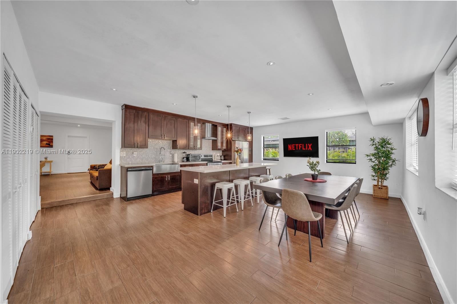 710 Northeast 141st Street North Miami, FL 33161 - Photo 9 of 78 a living room with lots of furniture and kitchen view