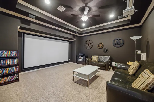 a living room with furniture and a ceiling fan
