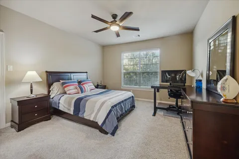 a bedroom with a bed and a desk