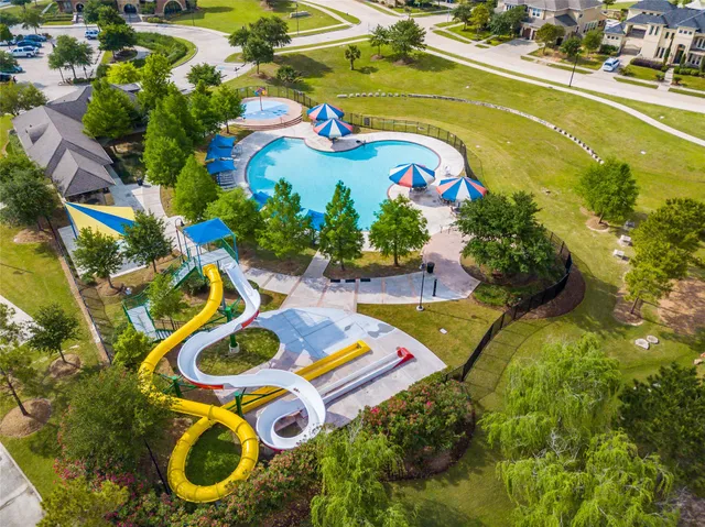 an aerial view of a house with swimming pool and outdoor space