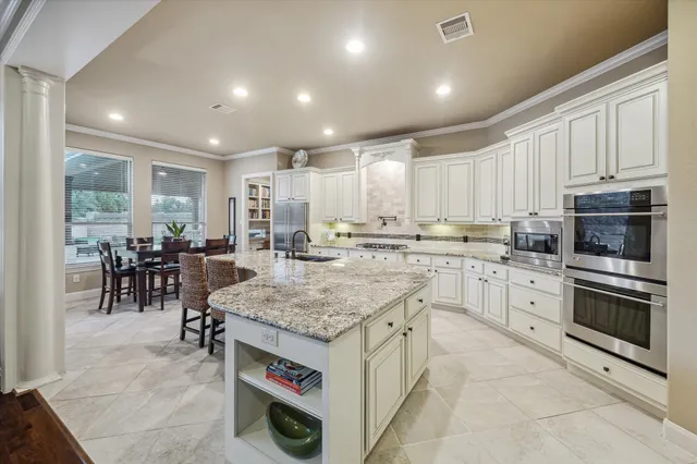 a kitchen with stainless steel appliances granite countertop a stove oven and a refrigerator
