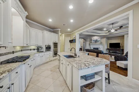 a view of living room with granite countertop furniture and a flat screen tv