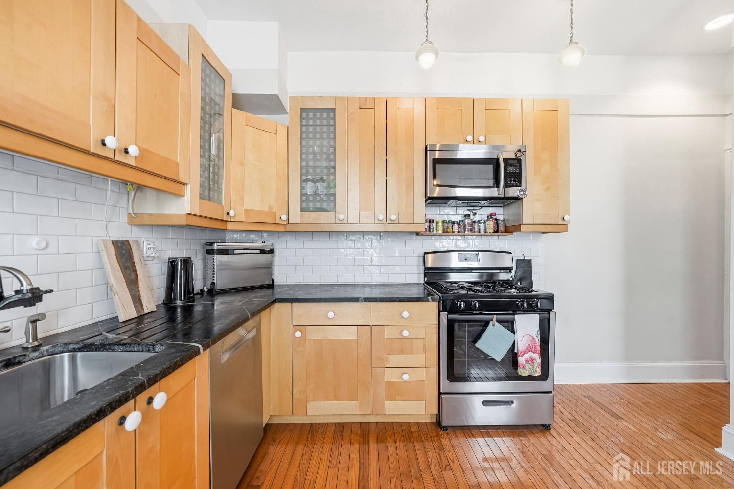 346 East Union Street Burlington, NJ 08016 - Photo 18 of 48 a kitchen with a stove a sink and a microwave