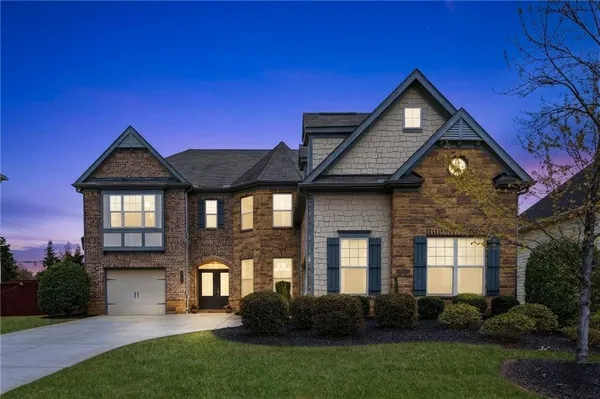 a front view of a house with a yard