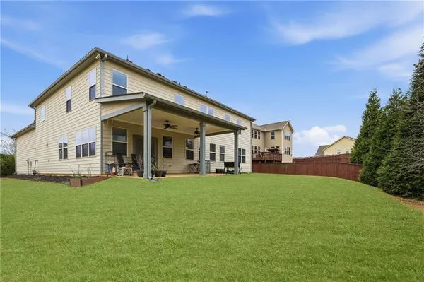 a front view of a house with a yard and porch