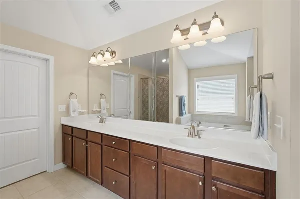 a bathroom with a double vanity sink and a mirror