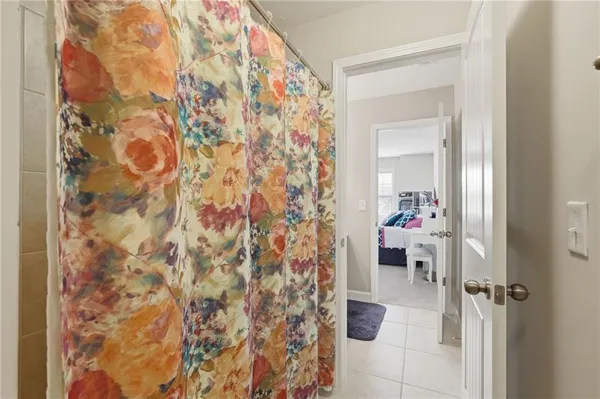 a bedroom with a bed and a chair in it