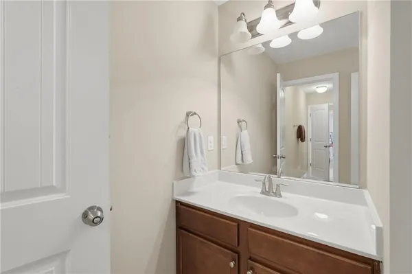 a bathroom with a sink vanity and a mirror