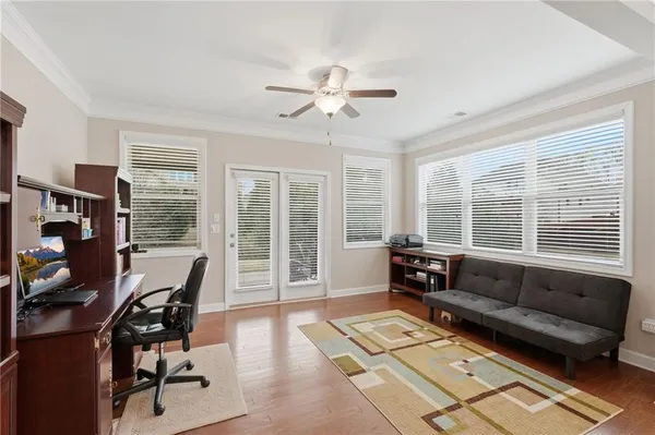 a living room with furniture and a floor to ceiling window