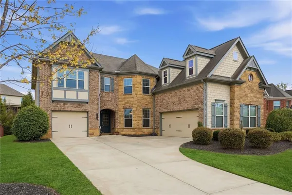 a front view of a house with a garden