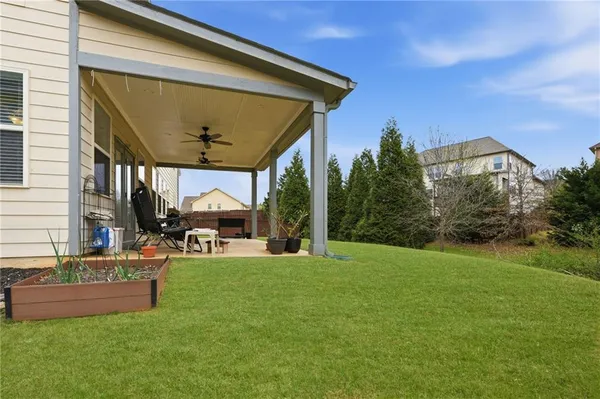 a view of a house with a backyard porch and sitting area
