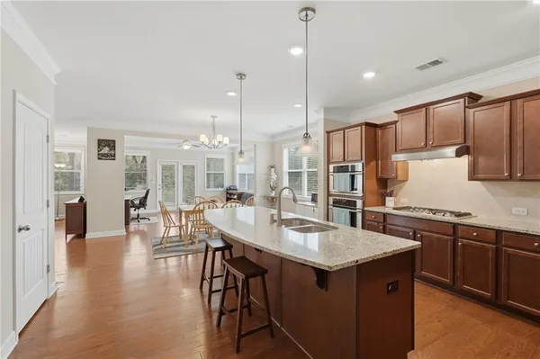 a kitchen with center island table and chairs