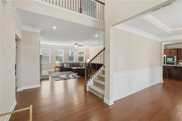 a view of entryway and hall with wooden floor