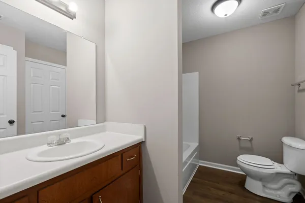 a bathroom with a sink toilet and mirror
