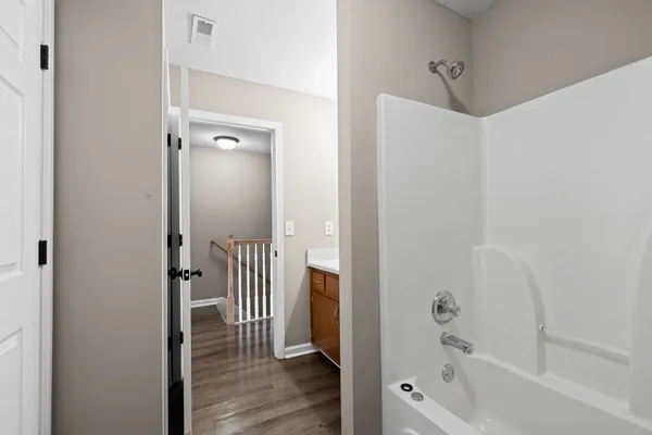 a bathroom with a bathtub and a shower