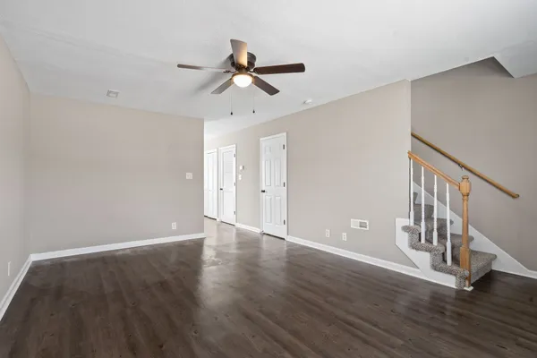 a view of an empty room with wooden floor