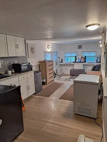 a large white kitchen with cabinets