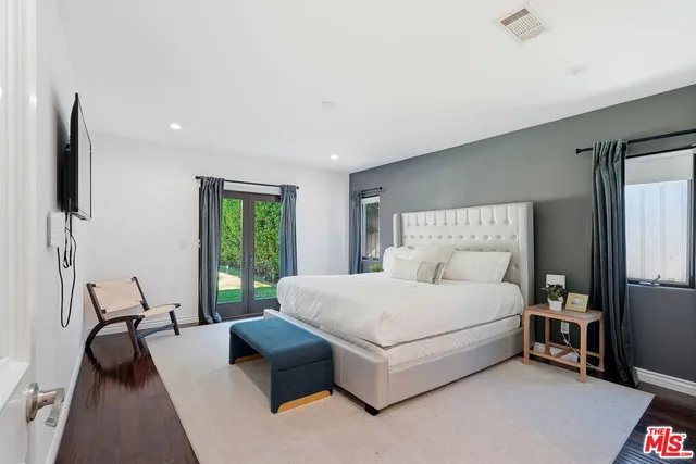 a bedroom with a bed couch and a window