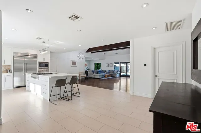 a living room with furniture and kitchen view