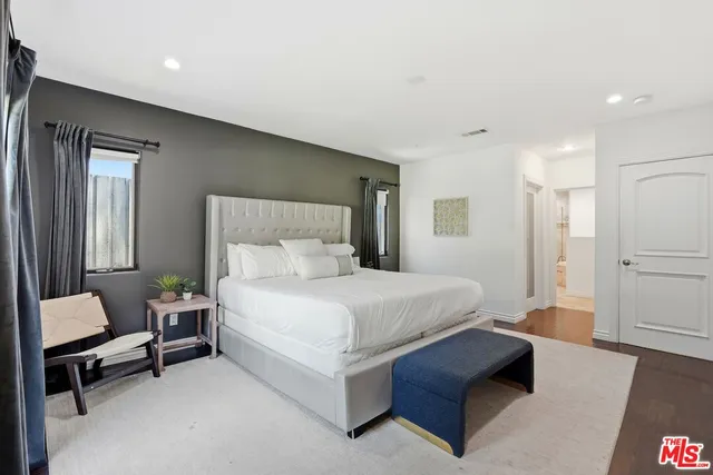 a spacious bedroom with a bed and a couch