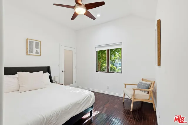 a bedroom with a bed and a chair