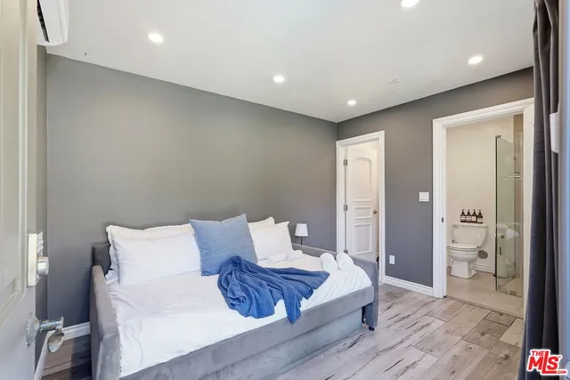 a spacious bedroom with a bed and a table