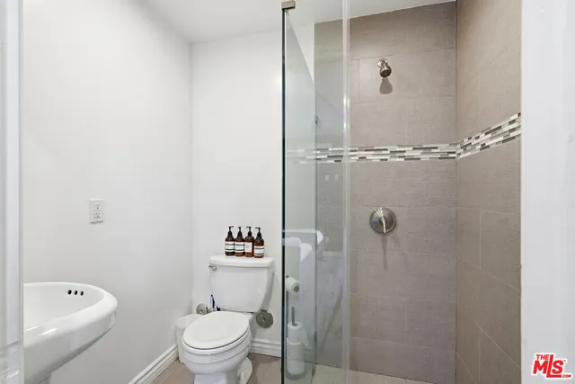 a bathroom with a toilet and a shower