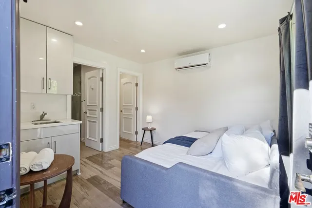 a large bedroom with a bed and furniture