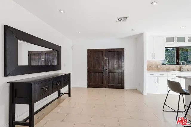 a room with a bed and a television