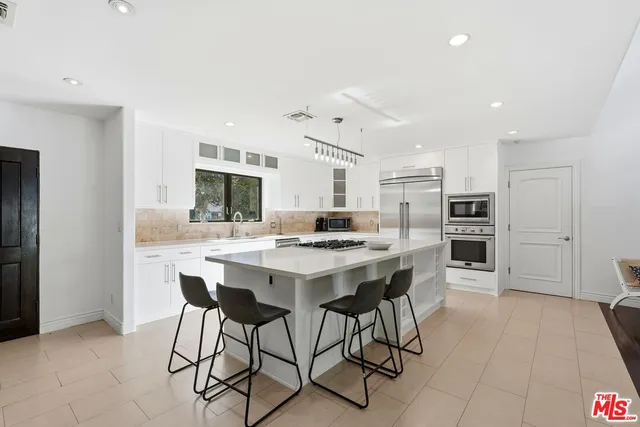 a kitchen with a table and chairs in it