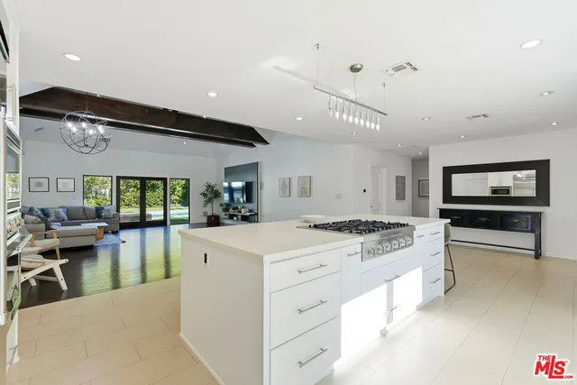 a kitchen with a stove a refrigerator and a stove top oven