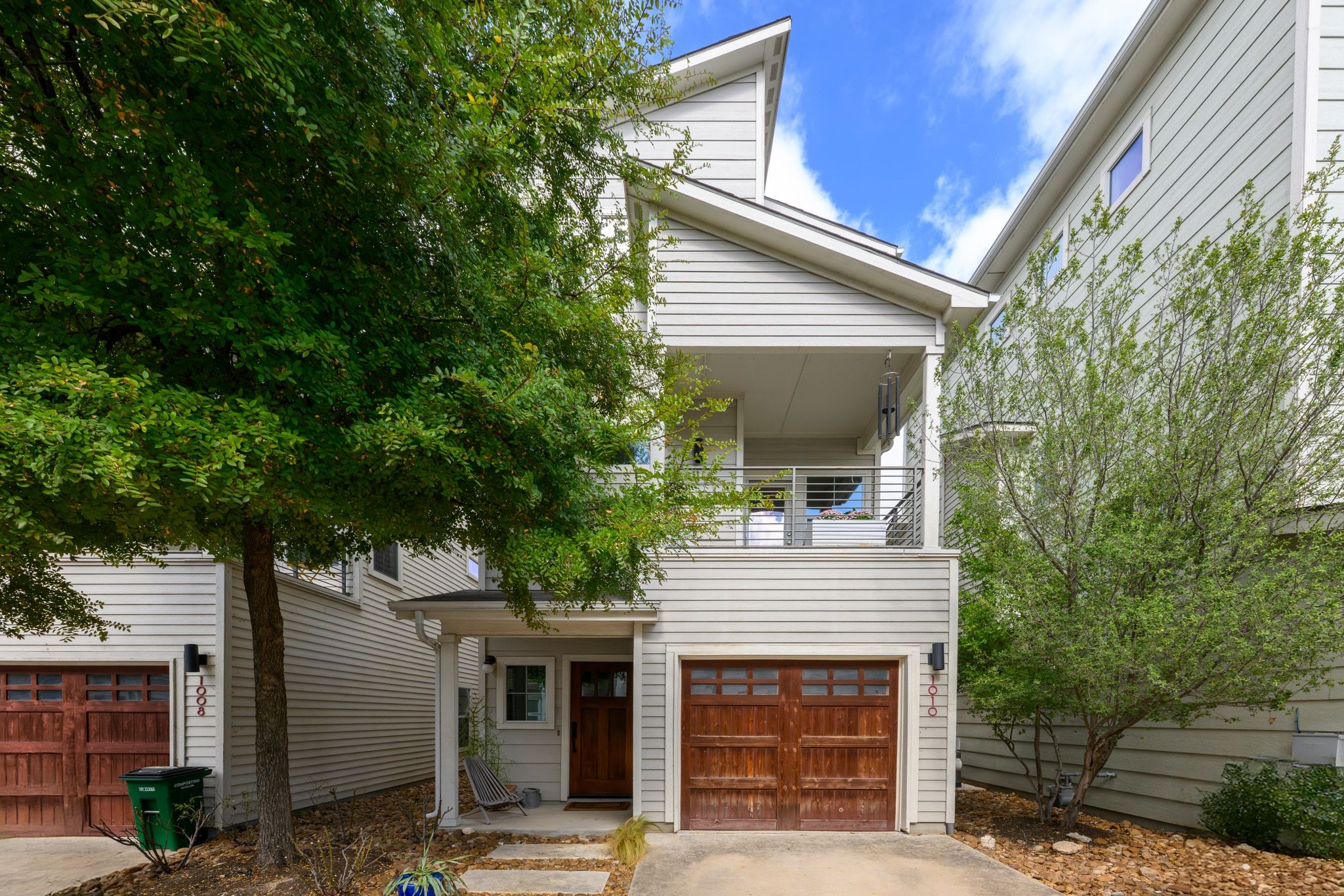 a front view of a house with a tree