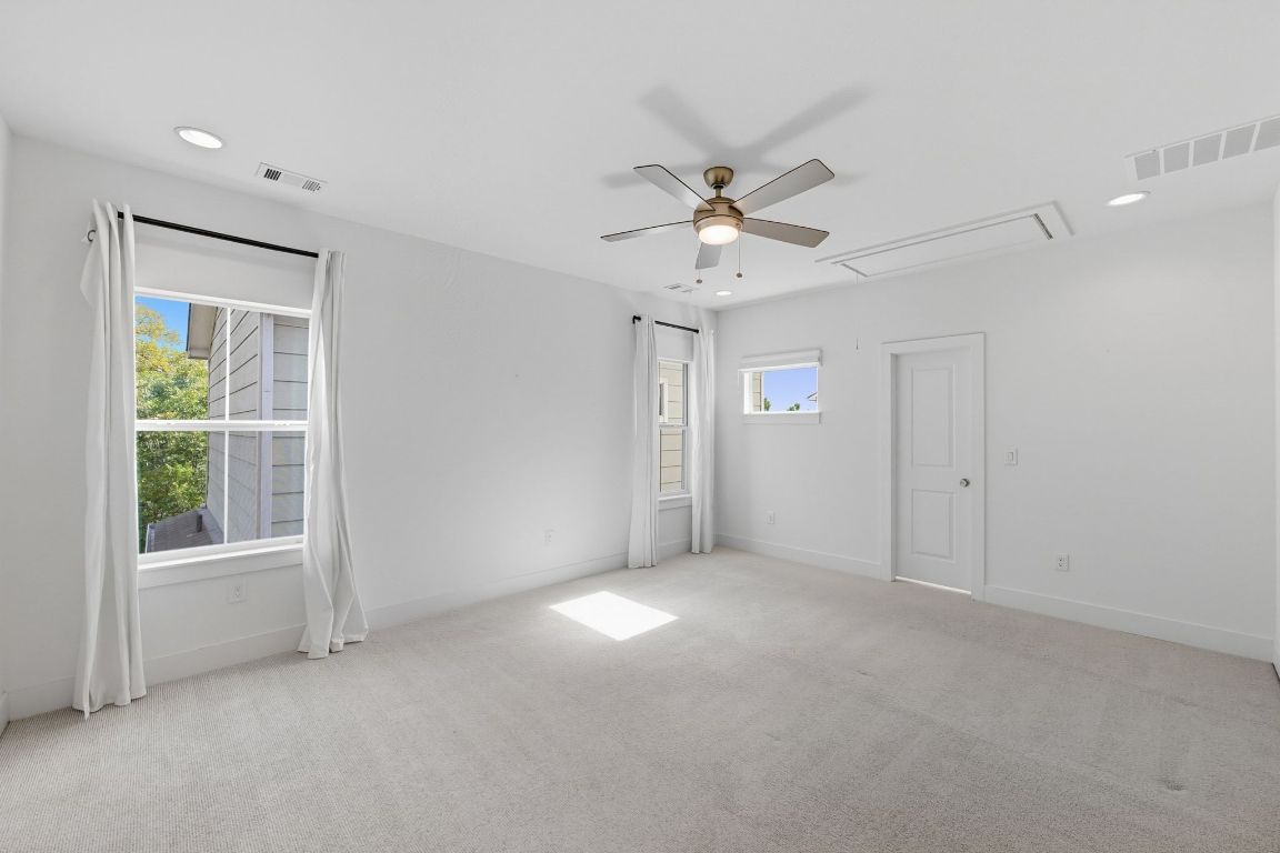 1010 Muse Lane, Unit 15 Austin, TX 78702 - Photo 10 of 22 an empty room with windows and fan