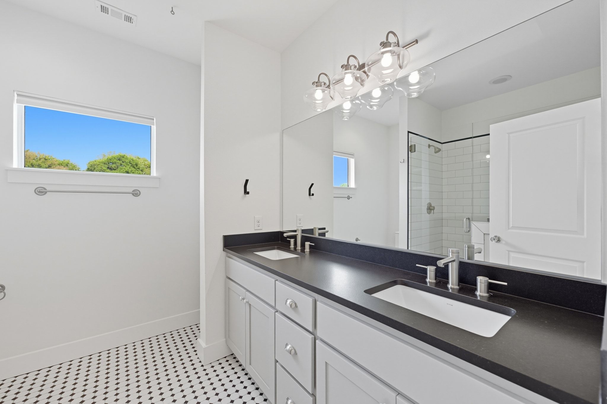 1010 Muse Lane, Unit 15 Austin, TX 78702 - Photo 12 of 22 a bathroom with a sink a large mirror and a shower