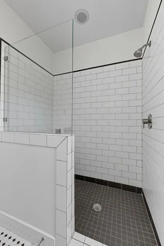 a bathroom with a sink a large mirror and a shower