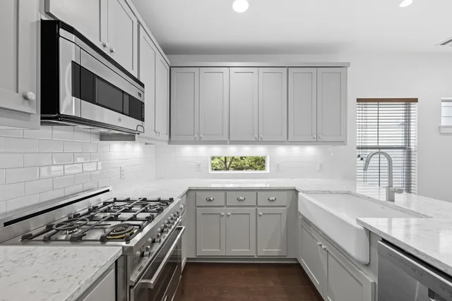 a kitchen with cabinets stainless steel appliances and cabinets