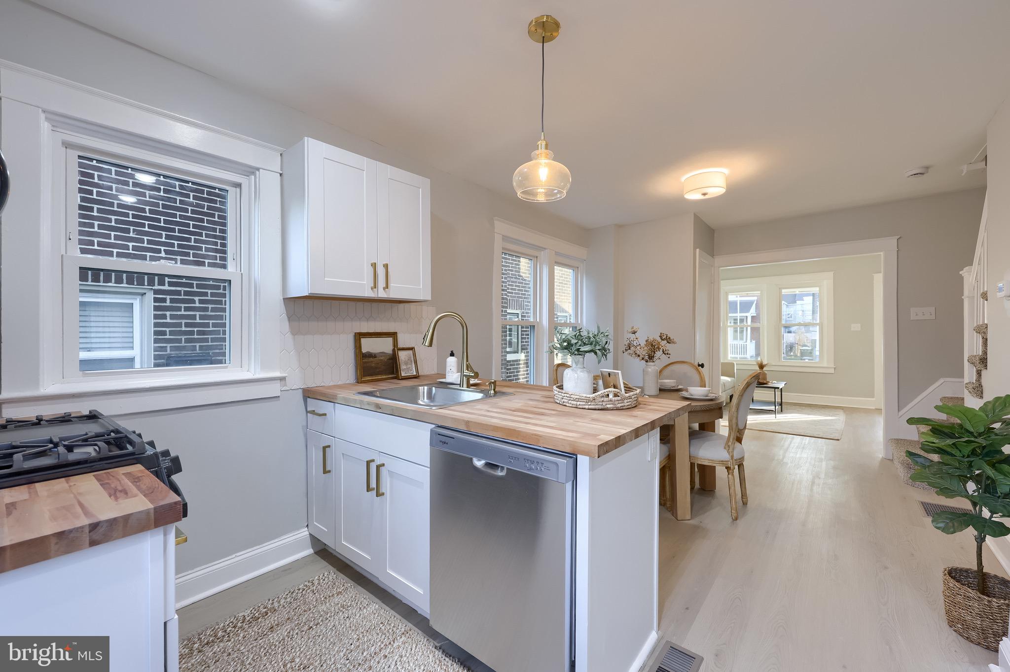 839 George Street Lancaster, PA 17603 - Photo 6 of 20 a kitchen with a stove a sink a counter space and dining table