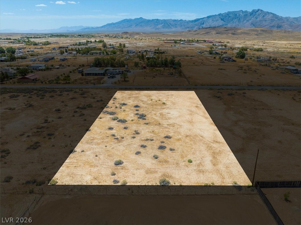 4610 Lawrence Road Pahrump, NV 89048 - Photo 26 of 42 A spacious, buildable parcel awaits, set against a distant mountain range.