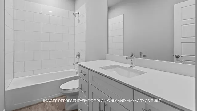 a bathroom with a granite countertop sink toilet a mirror and bathtub